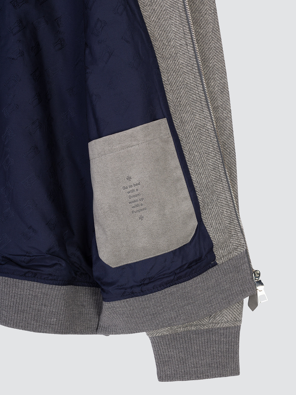 Open herringbone wool jacket showing the navy inner lining and the inside pocket