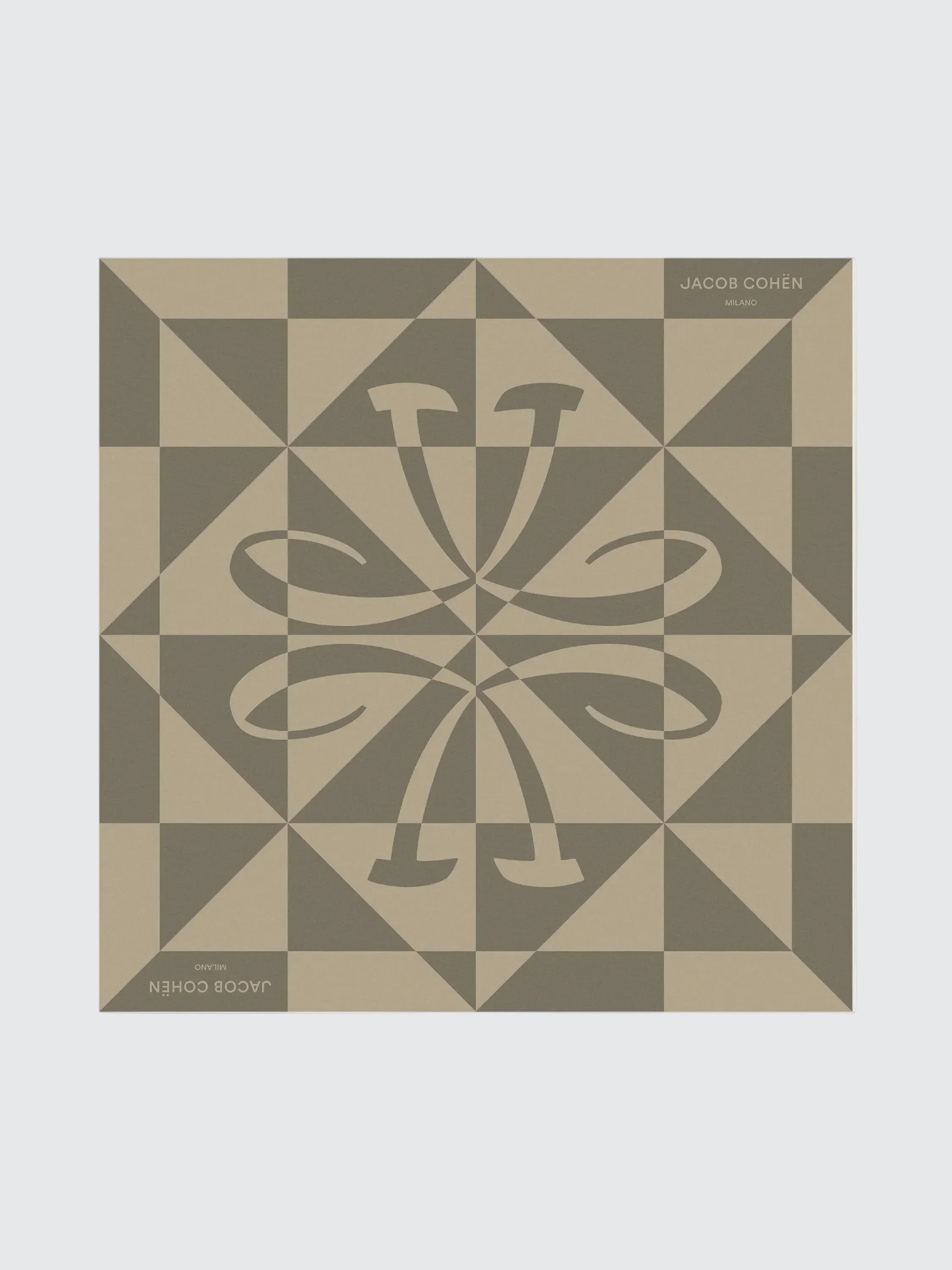 Decorative tile with geometric pattern and central design on a beige background