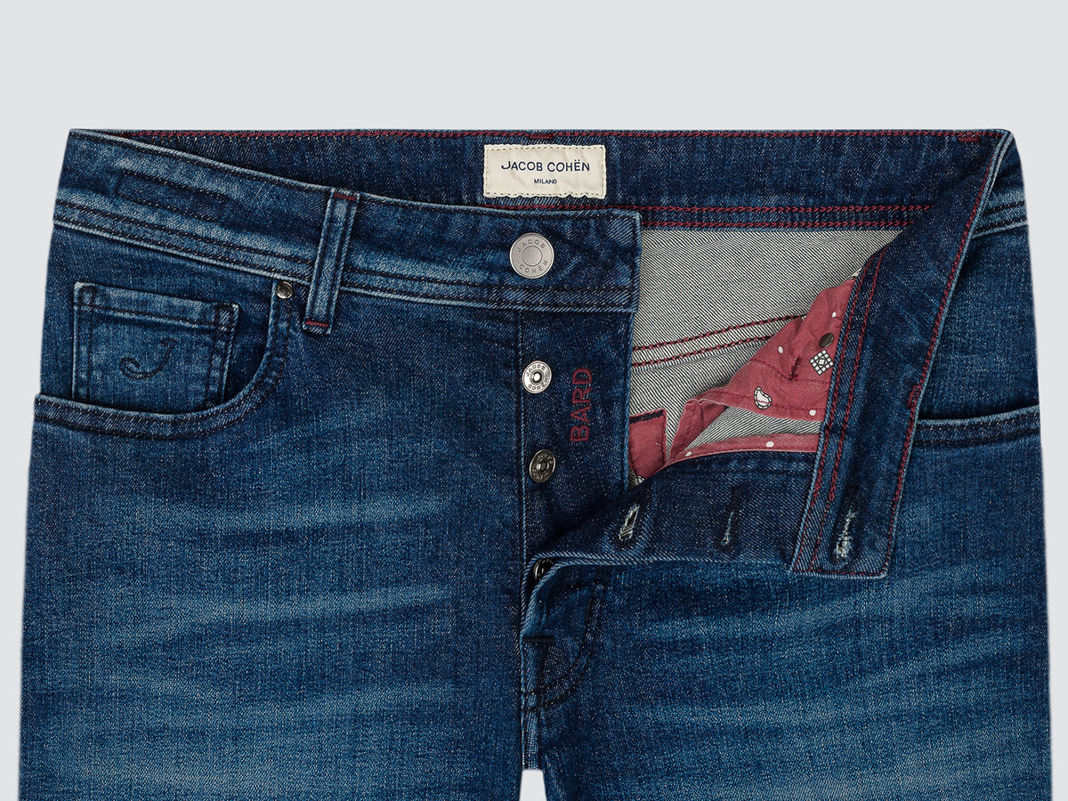 Close-up of the open button fly of the mid blue Bard jeans, with the Jacob Cohën waistband label