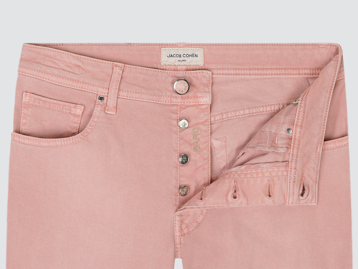 Close-up of the open button fly of the antique rose Bard trousers, with the Jacob Cohën waistband label
