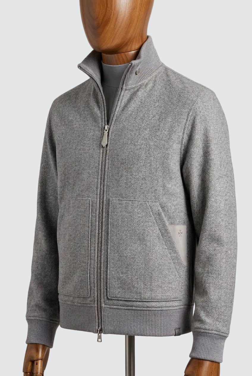 Stone grey herringbone wool jacket worn open over a roll neck, front view