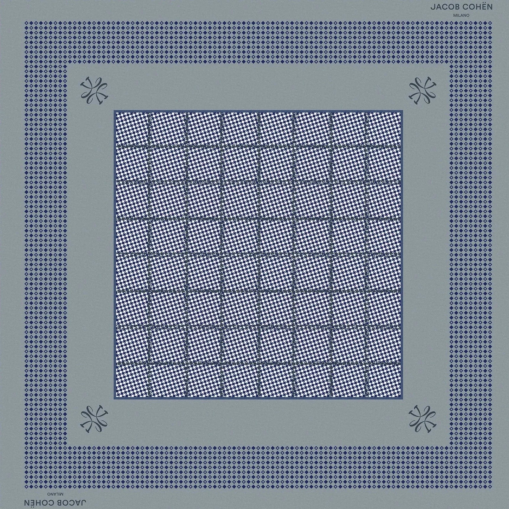 A square scarf by Jacques Coupin, featuring a geometric pattern in slate blue and navy blue on a light beige background.