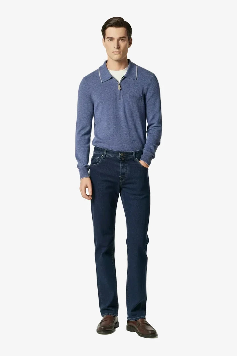 Model wearing the heathered slate blue cashmere long-sleeve polo by Jacob Cohën with dark blue jeans and brown leather shoes, full-length front view.