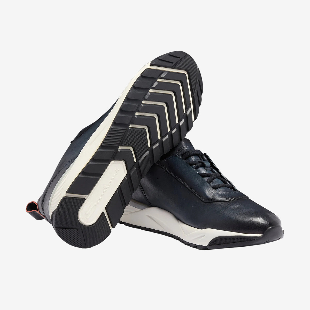 Pair of navy Innova sneakers, one tilted to show the chevron-tread outsole