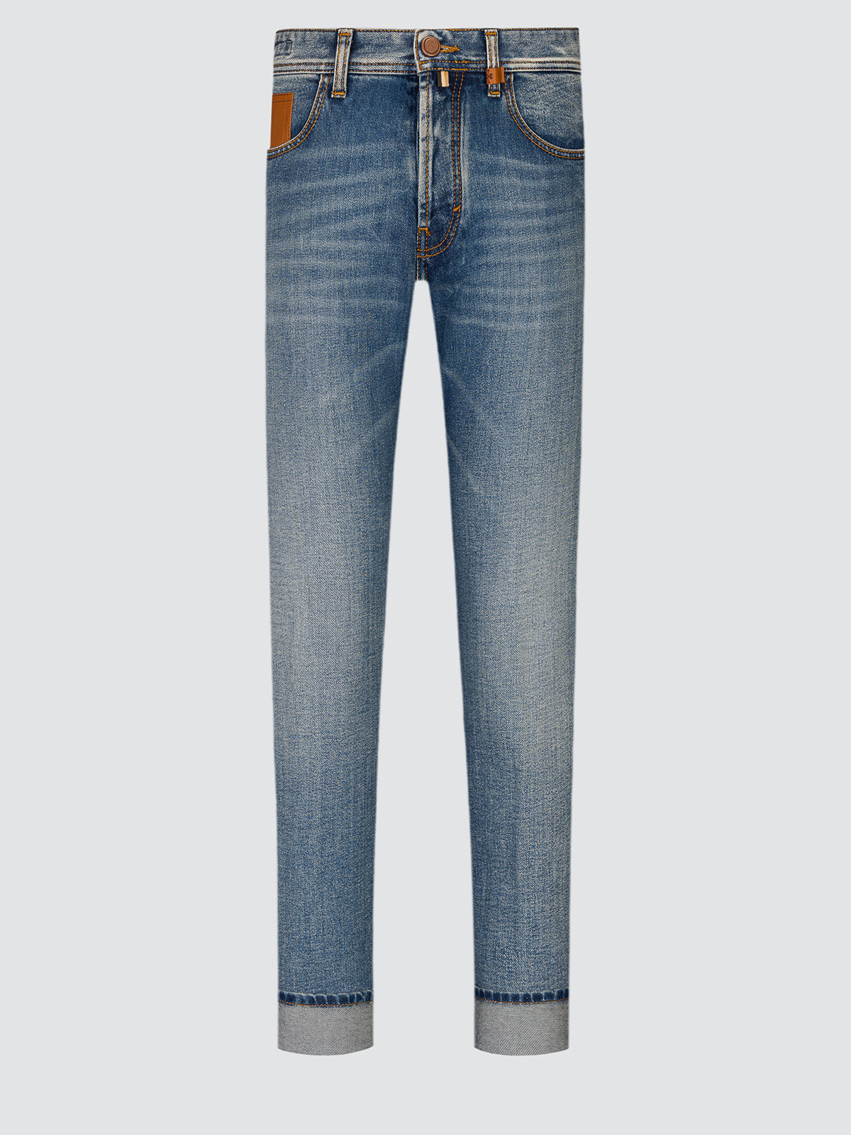 Full-length front view of Jude jeans in dark blue pure cotton denim laid flat, with a tapered leg and turned-up hem.