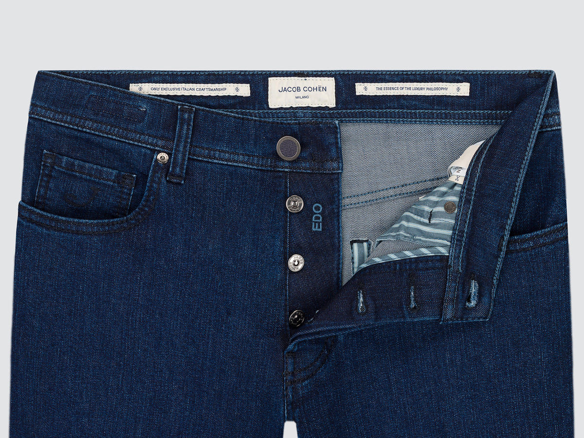 Close-up of the open button fly of the dark blue Edo jeans, showing the inner labels