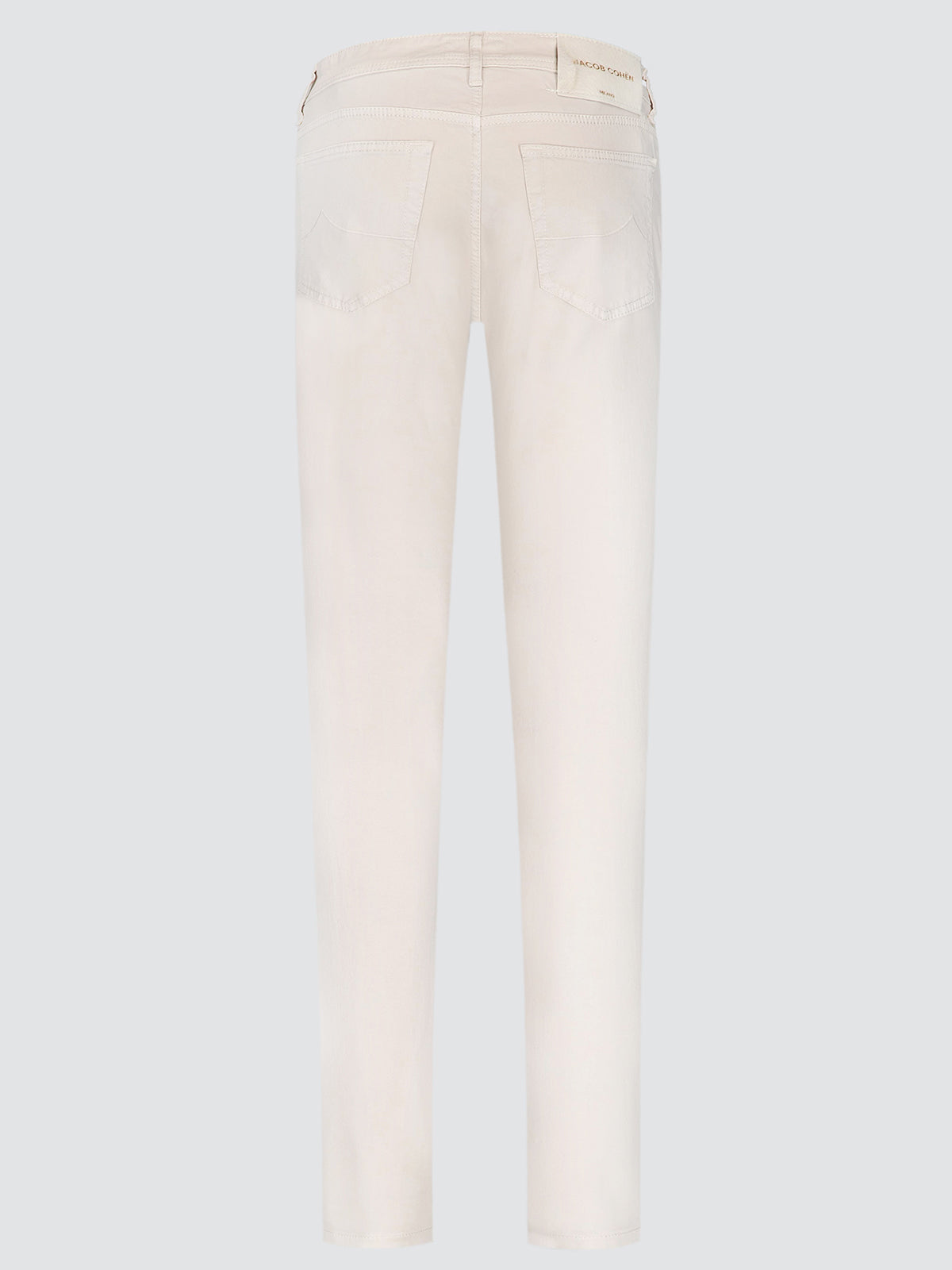 Back view of a pair of light cream or off-white slim-fit jeans on a solid light gray background.