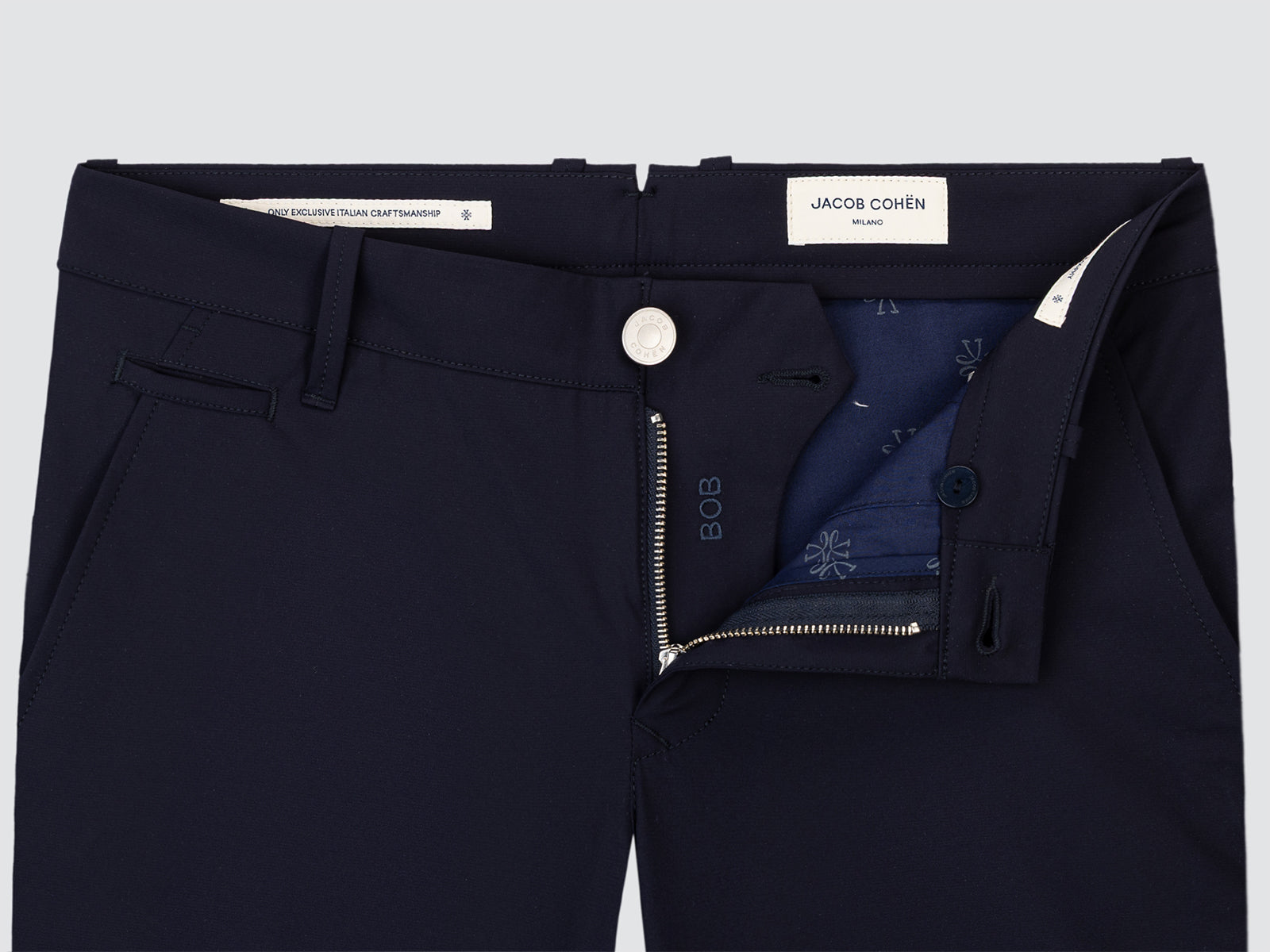 Navy blue shorts with a brand label Jacob Cohen on a light gray background