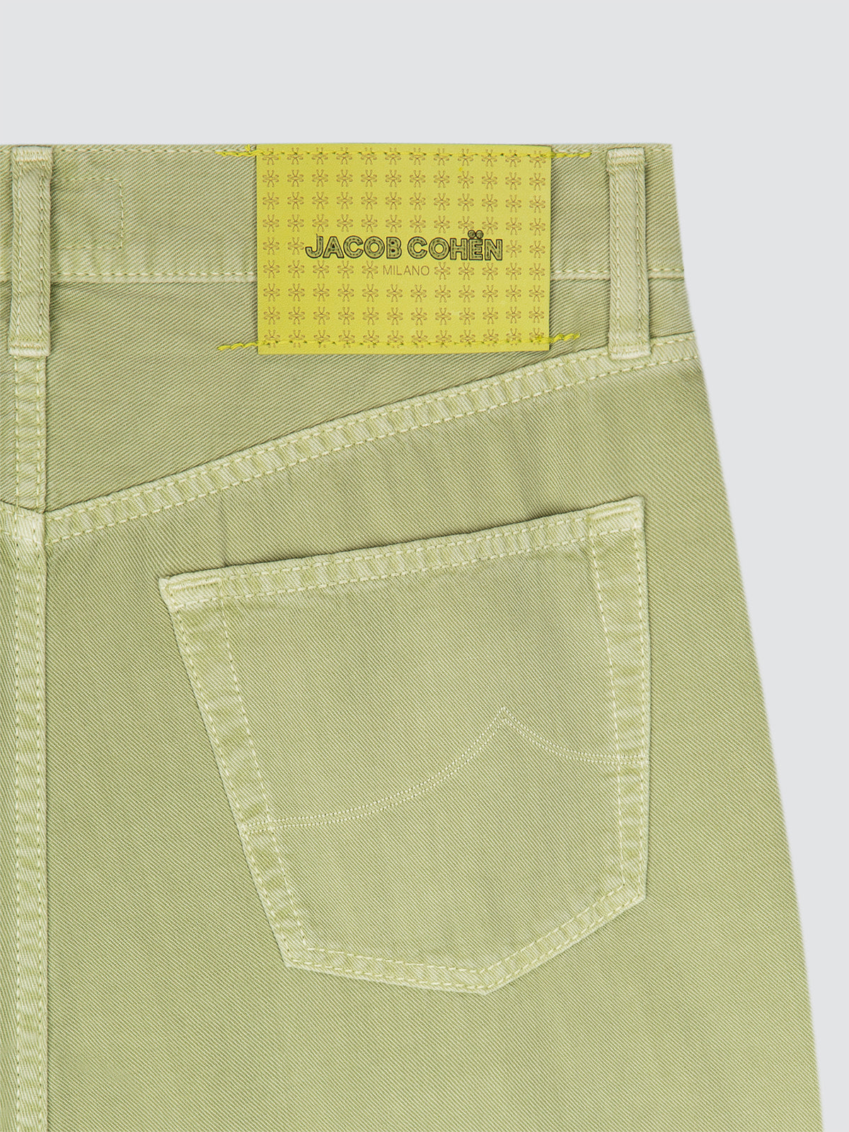Green pants with a visible brand label Jacob Cohën on a white background