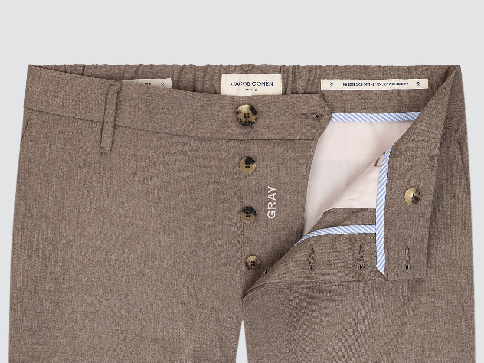 Brown pants with visible brand label on a light gray background
