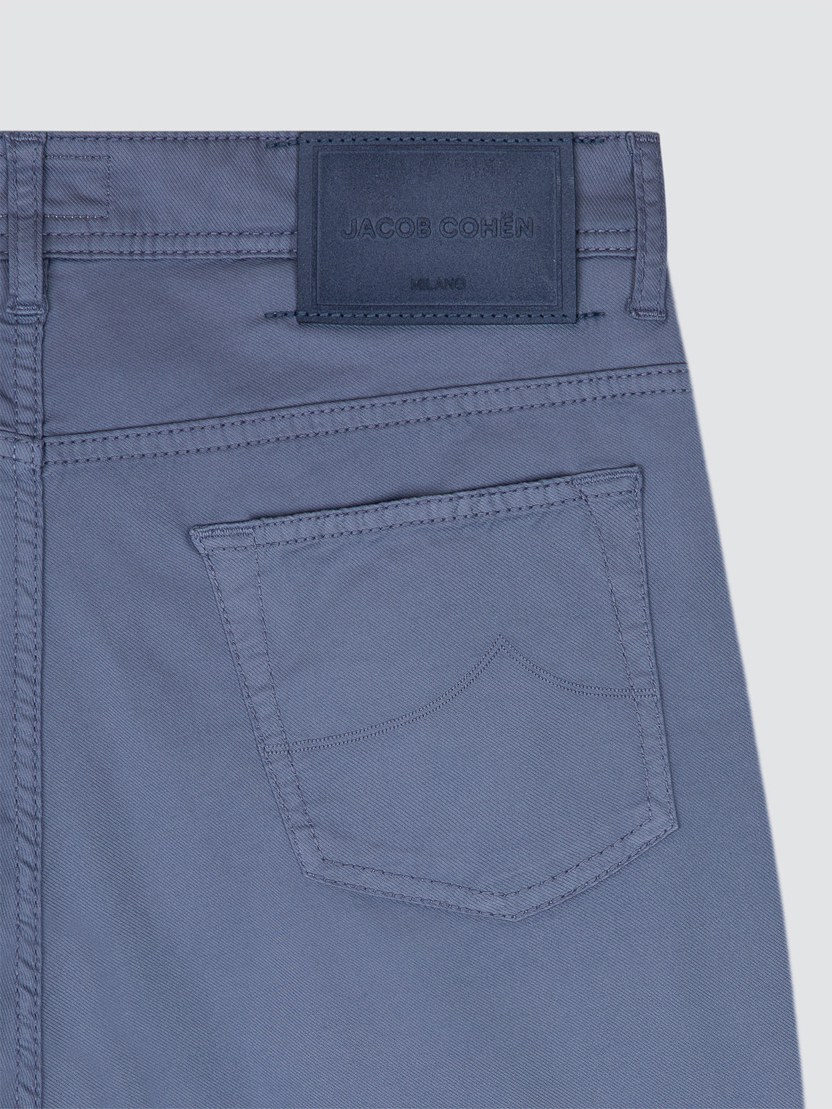 Blue pants with a brand label on a light gray background