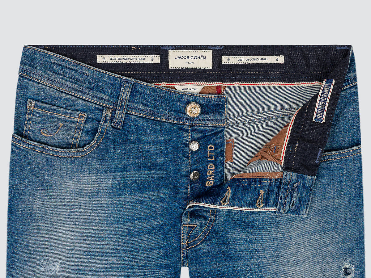 Close-up of the open button fly of the Bard LTD jeans, with the Jacob Cohën waistband labels