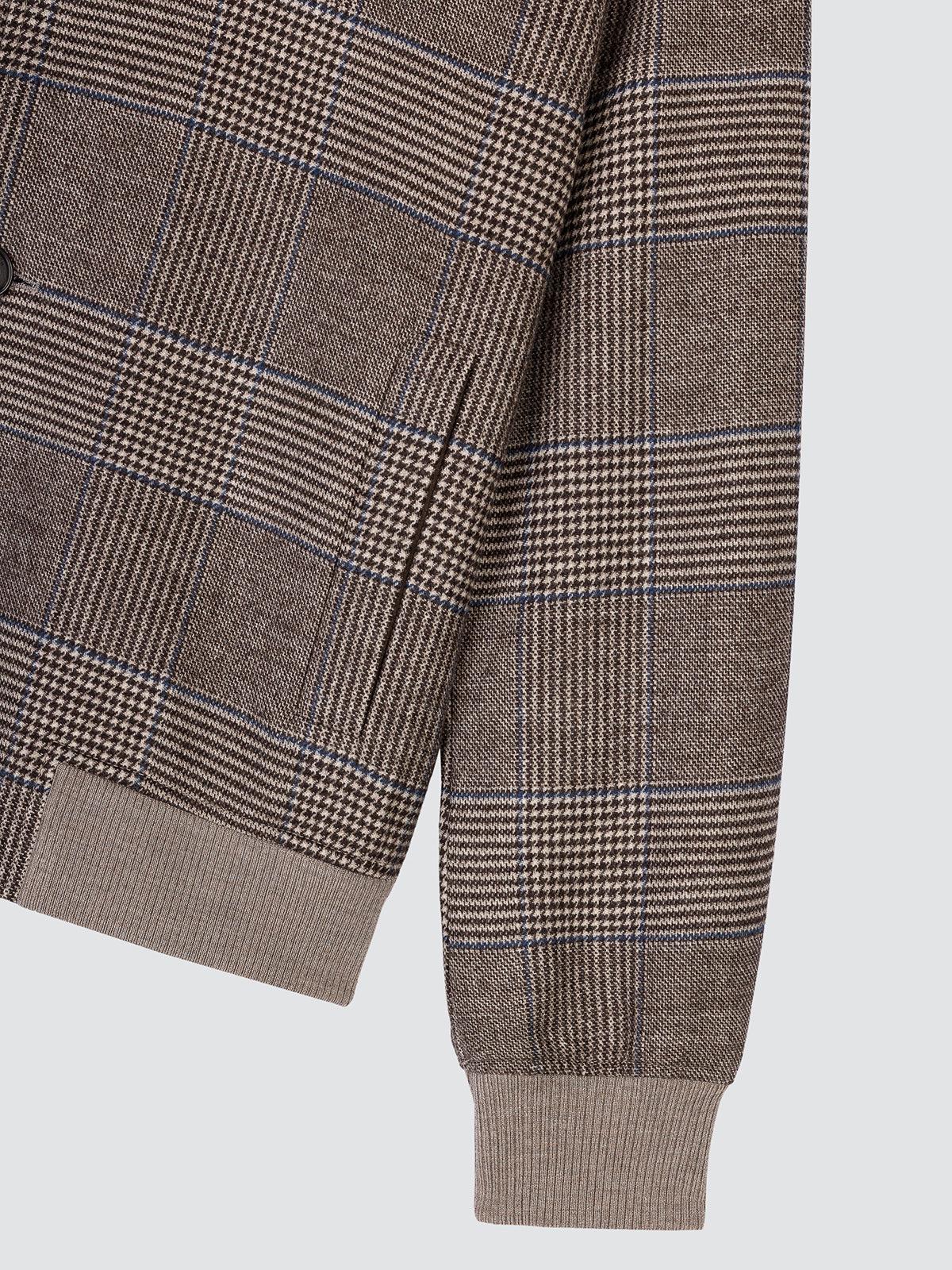Close-up of the folded sleeve and ribbed cuff of the Prince of Wales check flannel jacket.
