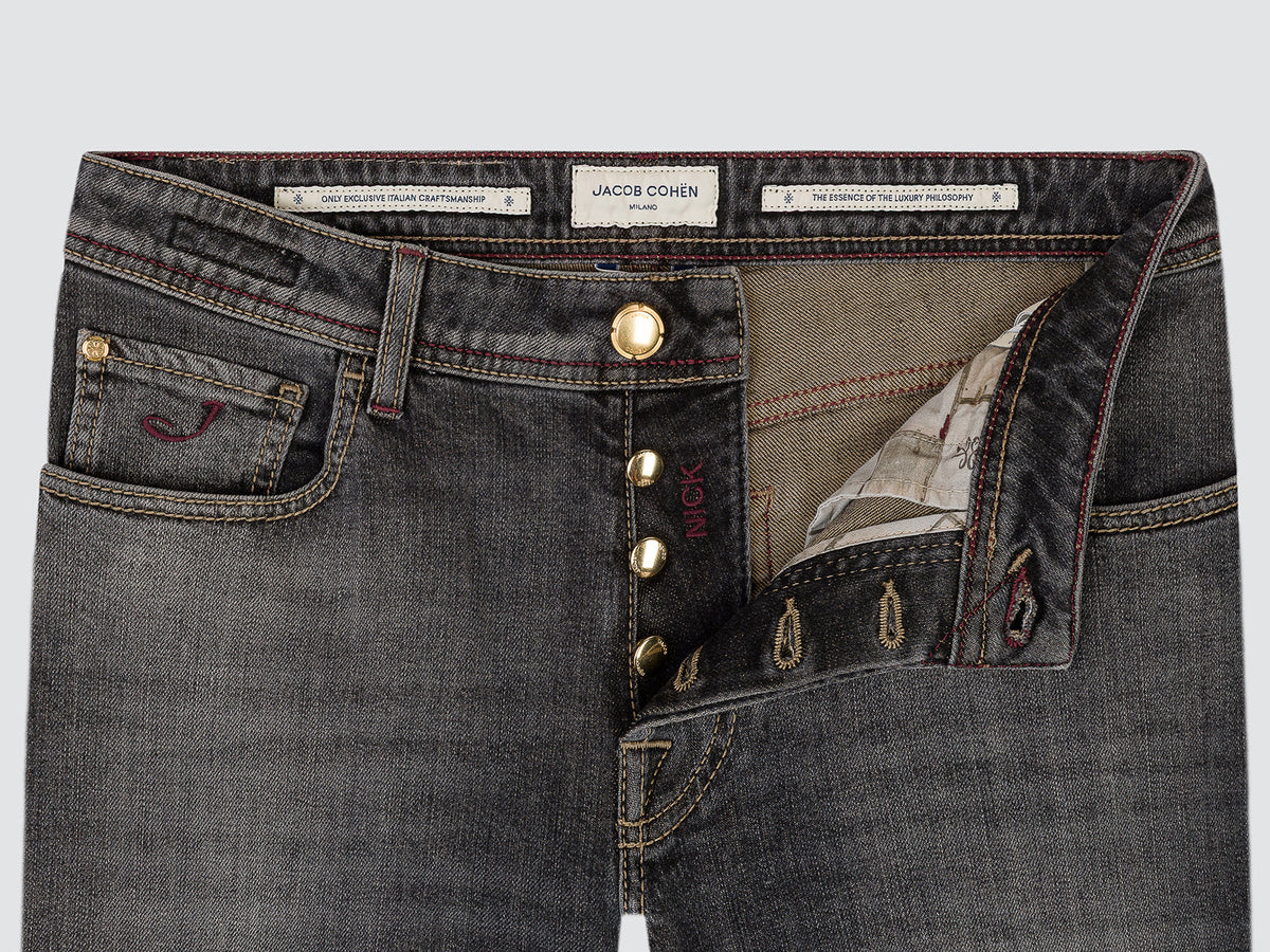 Close-up of the open button fly of the grey Nick jeans, with the Jacob Cohën waistband labels