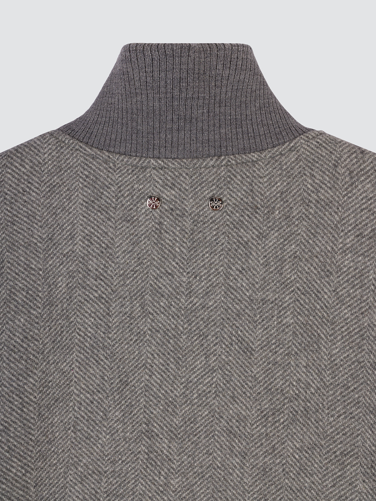 Close-up of the stand collar and herringbone weave of the wool jacket
