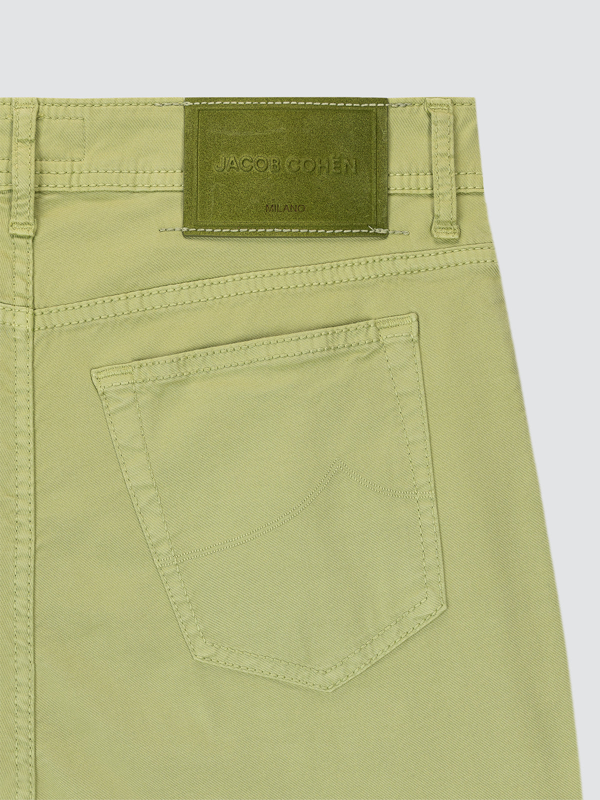 Green pants with a brand label on a white background