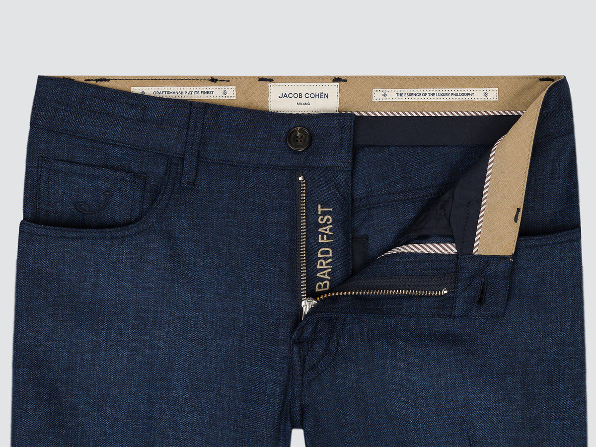 Close-up of the open button fly of the dark blue Bard wool trousers, with the Bard Fast inner label
