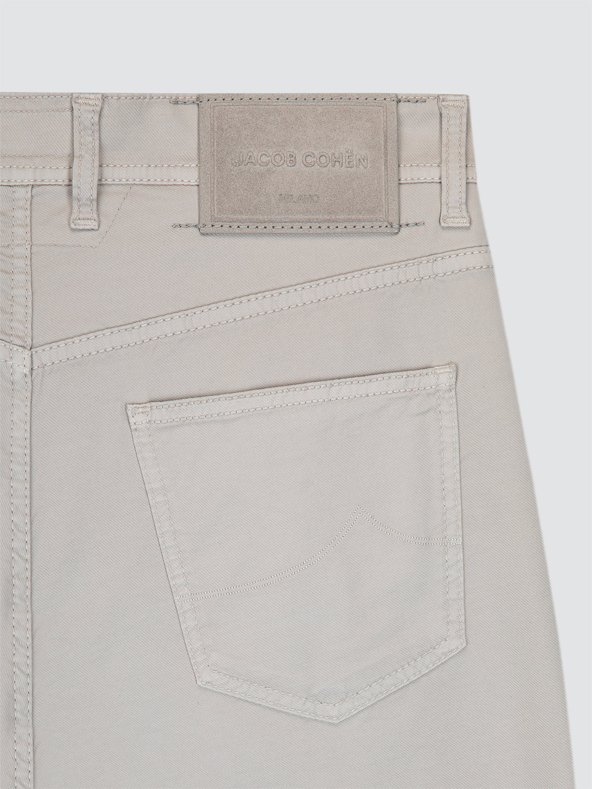 Close-up of light grey bermuda Jacob Cohën with a brand label on a white background