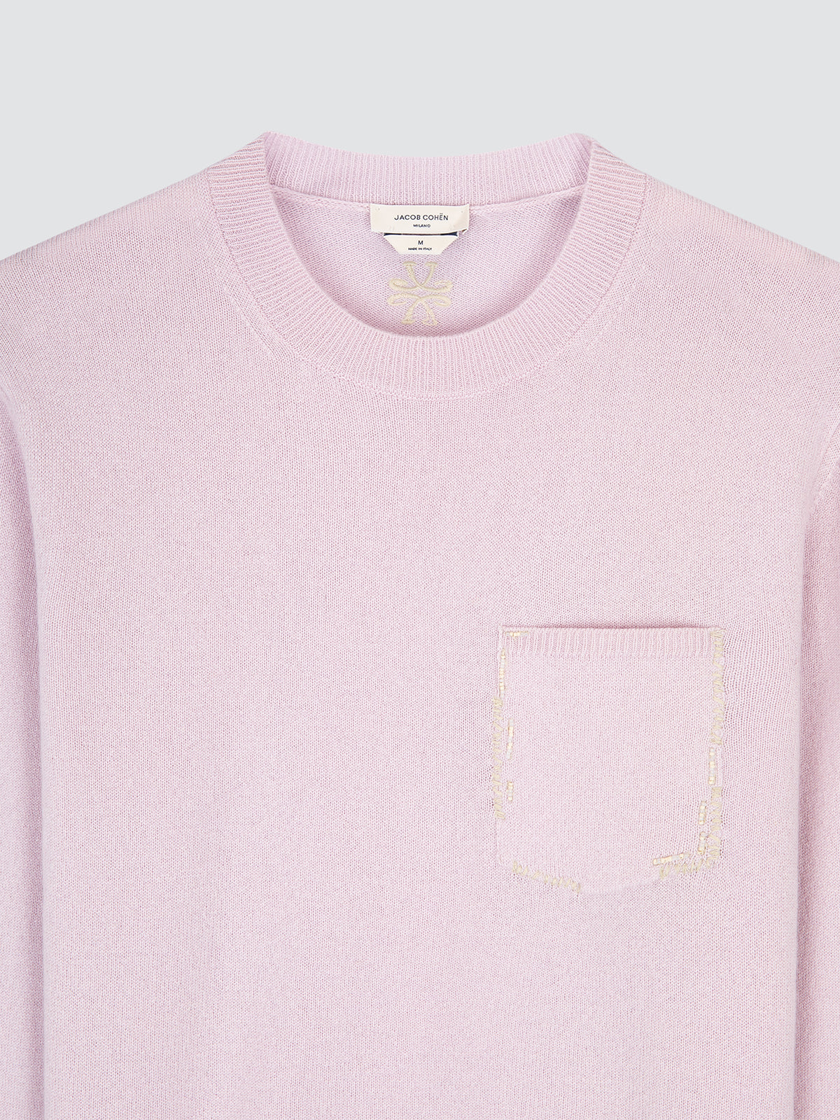 pastel Pink sweater with a pocket detail on a light gray background