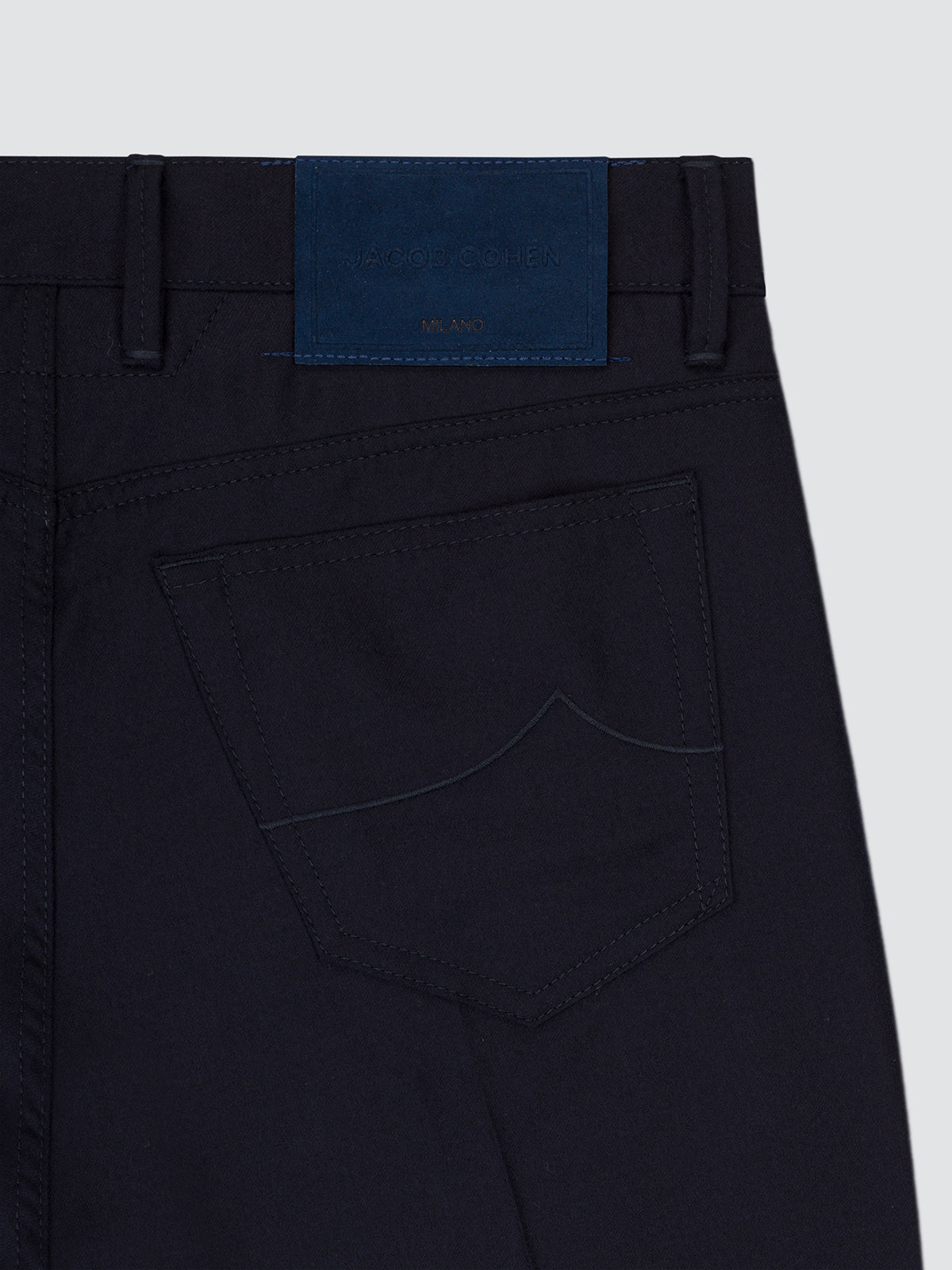 Close-up of the back pocket of the navy flannel Bard trousers, with the blue patch at the waistband