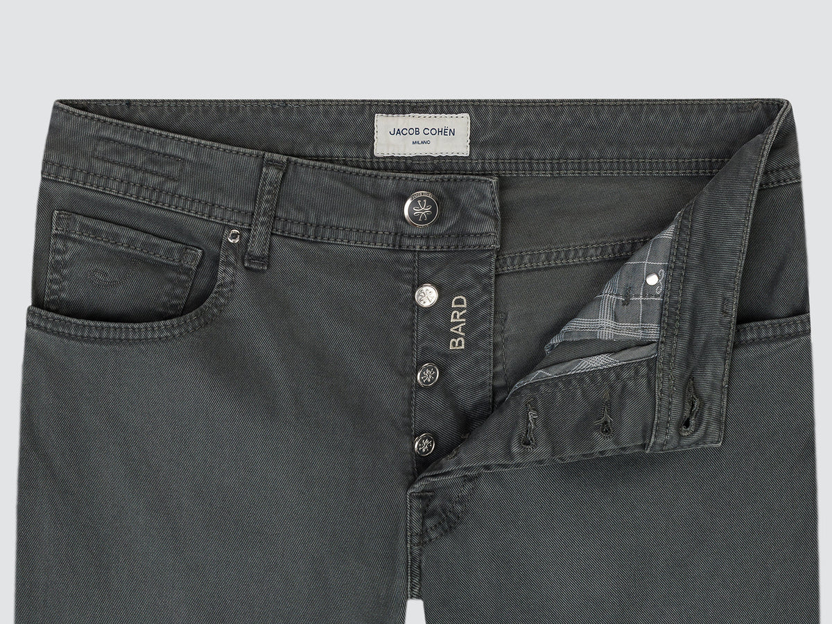 Close-up of the open button fly of the grey Bard trousers, with the Bard-engraved buttons