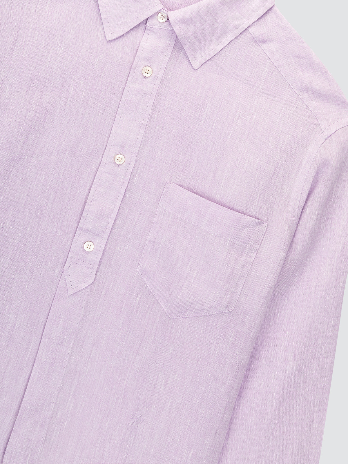 Close-up of a light purple shirt with button details on a white background