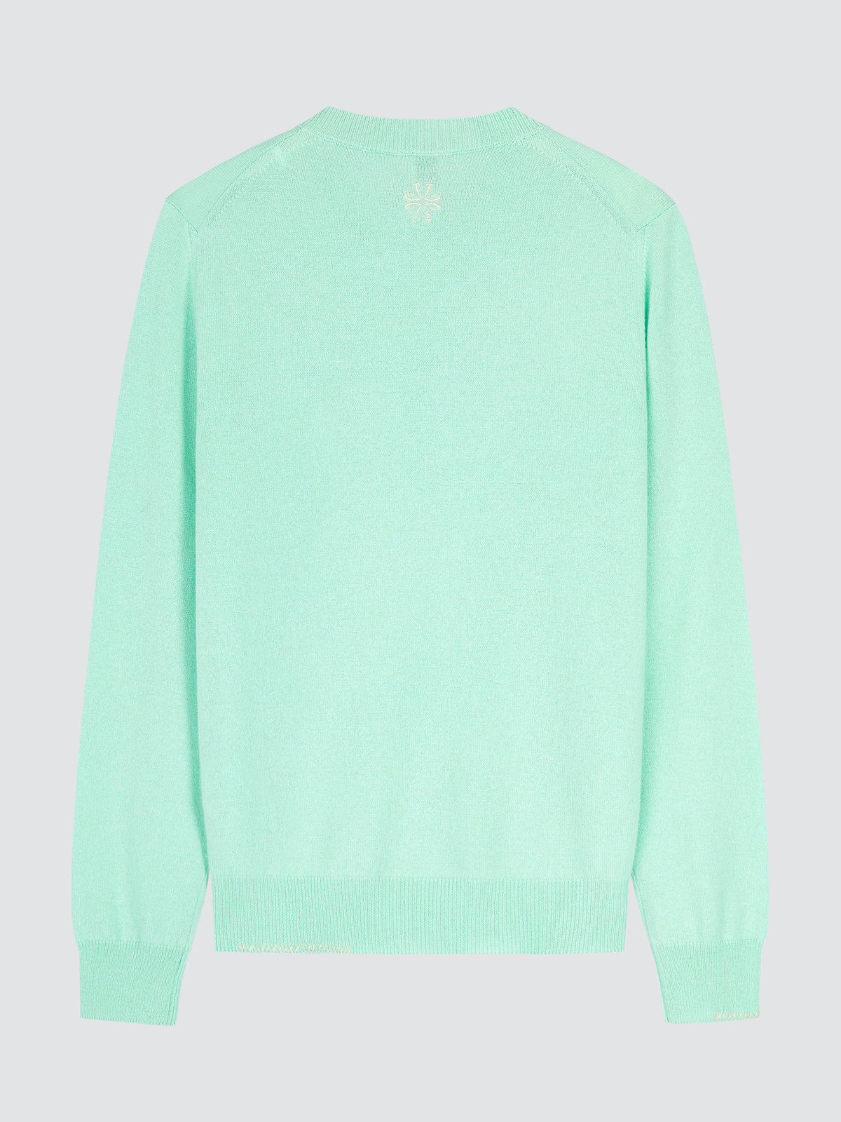 Light green sweater on a light gray background