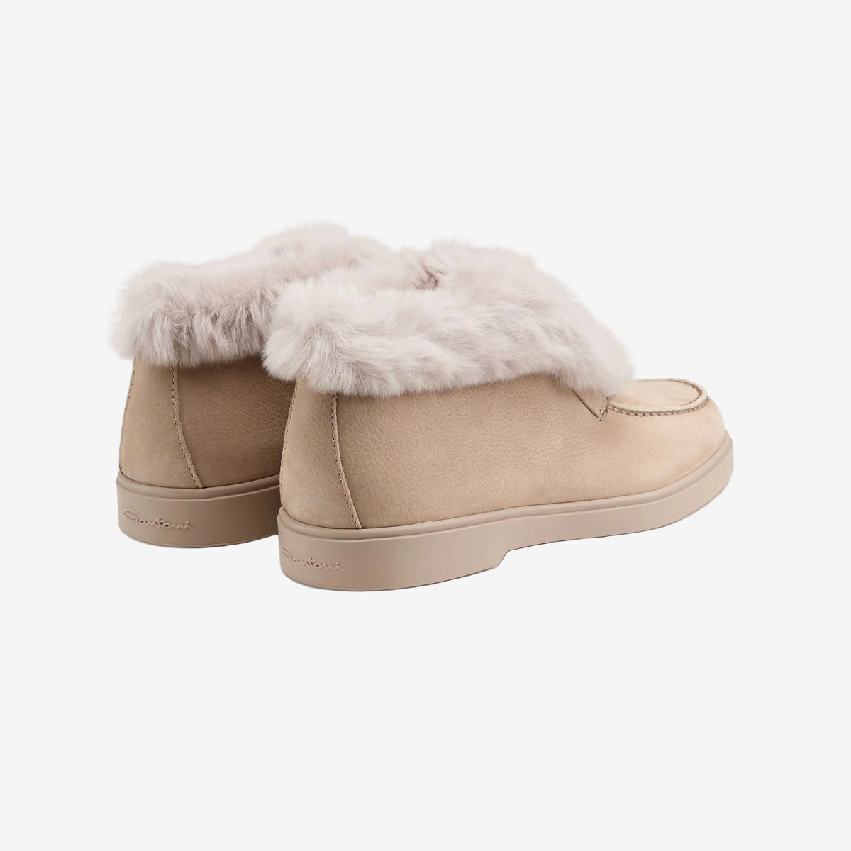 Back three-quarter view of the pair of beige fur-lined desert boots