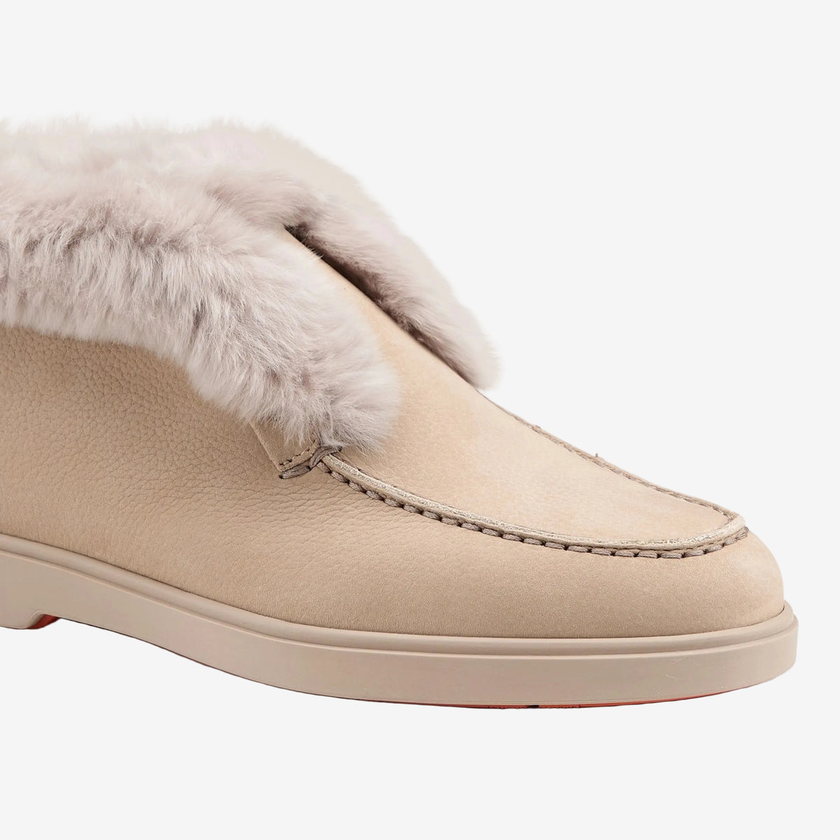 Close side view of the dark beige suede upper and shearling collar